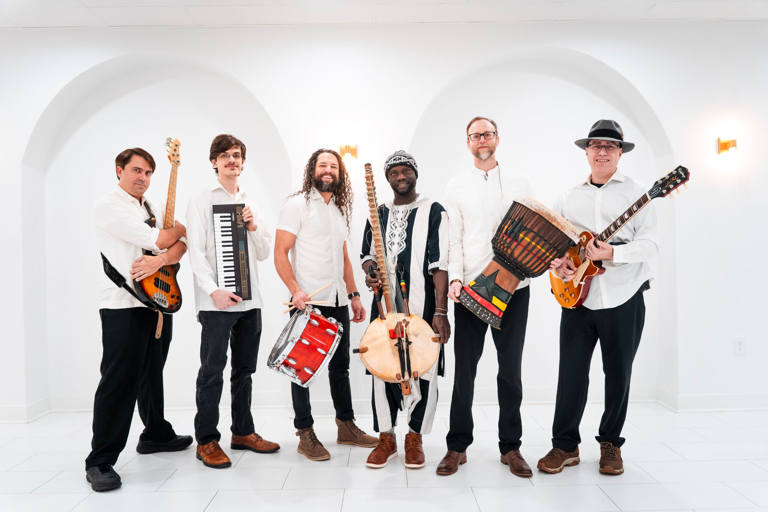 The entire 6-person band posing for a portrait.